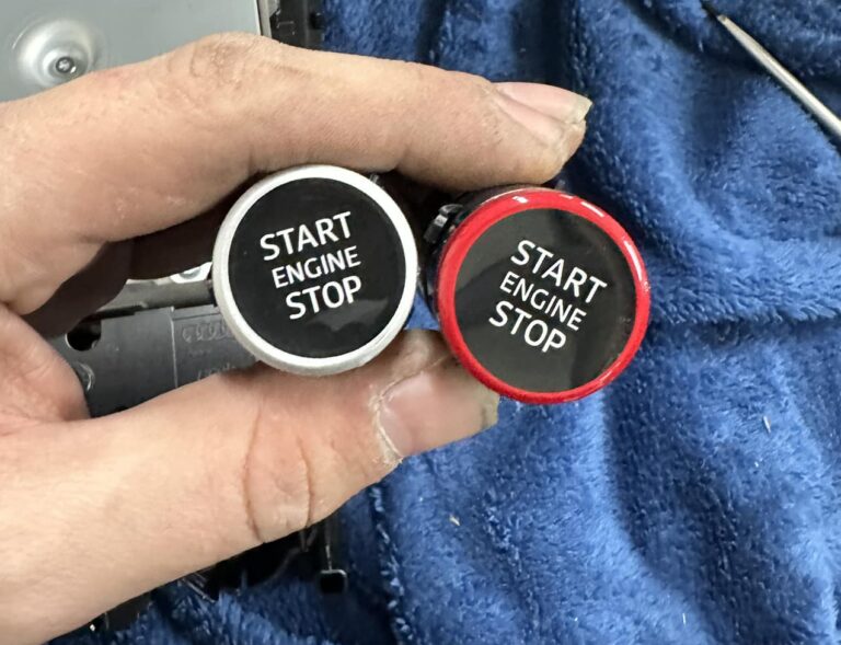 Technician installing Audi retrofit hardware on vehicle
